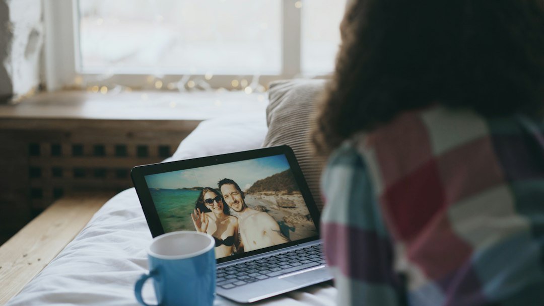 Frases de boa noite para amor a distância: 24 opções 2 Pessoa sorrindo durante uma conversa por vídeo à distância